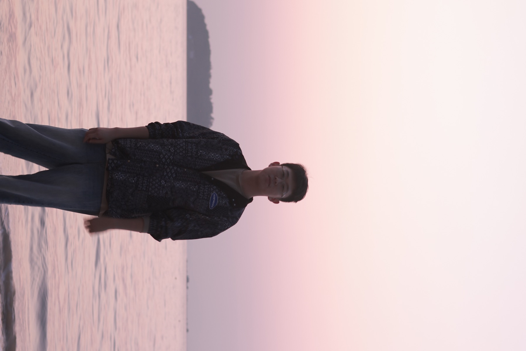 Yikun Wang by the sea at sunset